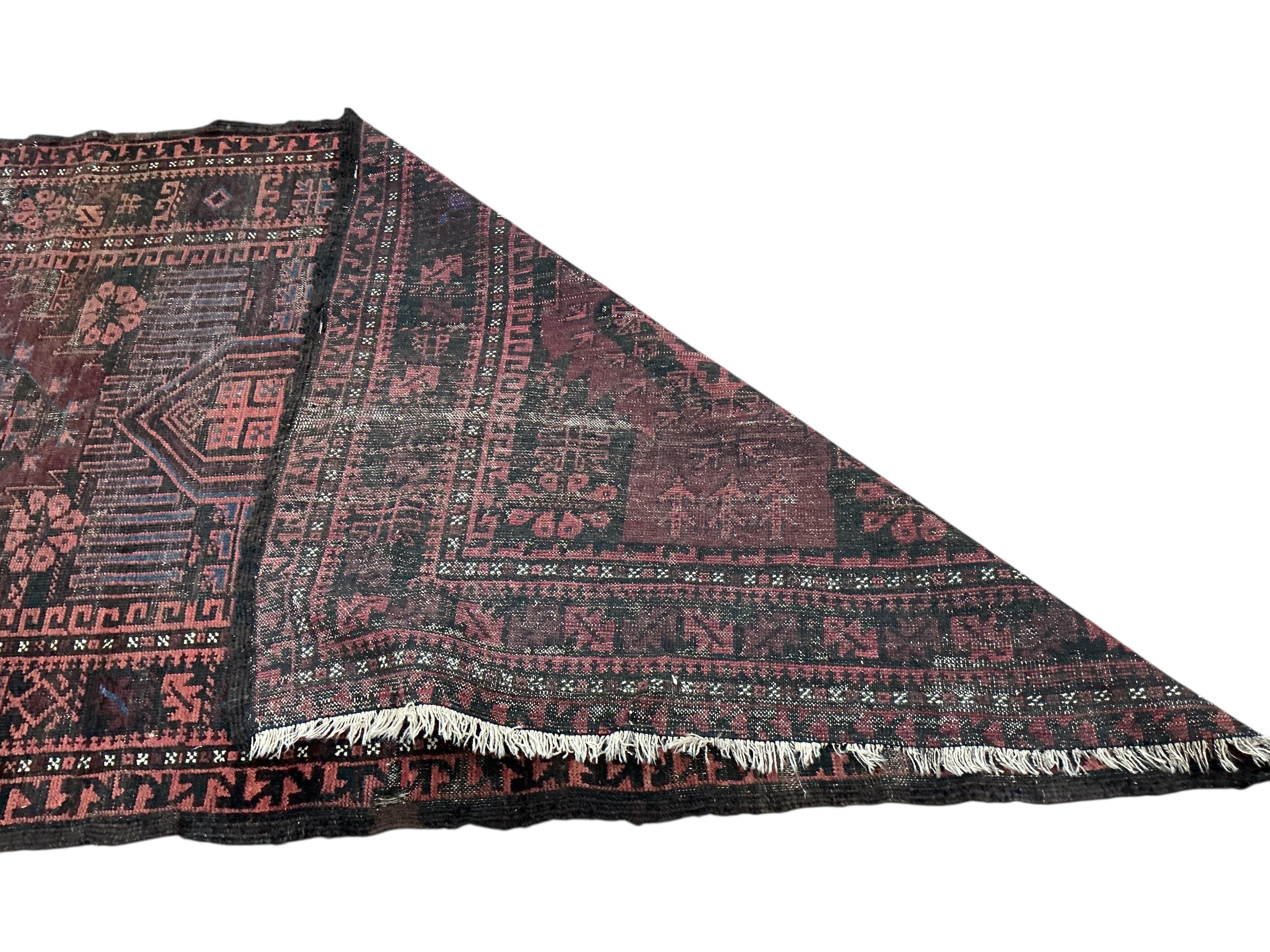 Two Belouch tribal rugs and an Afghan tribal rug, largest 200 x 110cm